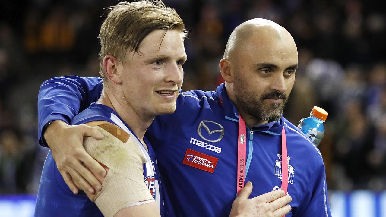 MELBOURNE, AUSTRALIA - AUGUST 02: Jack Ziebell of the Kangaroos and Rhyce Shaw, Interim Senior Coach of the Kangaroos embrace after a win during the 2019 AFL round 20 match between the North Melbourne Kangaroos and the Hawthorn Hawks at Marvel Stadium on August 02, 2019 in Melbourne, Australia. (Photo by Dylan Burns/AFL Photos)