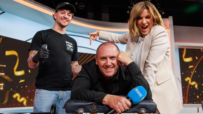 Daily Telegraph. 19, August, 2024.Tattooist, Zach Spiros, Logies winner Larry Emdur and Kylie Gillies, as Larry gets his tattoo live on air on The Morning Show, in Eveleigh, today. Picture: Justin Lloyd.