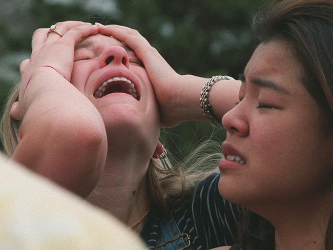 That day ... Columbine High School students react at a triage scene near the school in Littleton, Colorado. Picture: AP Photo/RockyMountainNews.