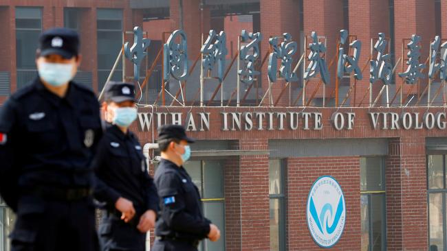 Security personnel keep watch outside the Wuhan Institute of Virology during the visit by the World Health Organisation.