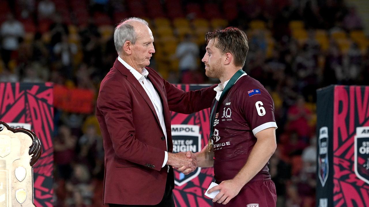 BRISBANE, AUSTRALIA - NOVEMBER 18: Cameron Munster of the Maroons is presented with the man of the match award by Maroons coach Wayne Bennett after game three of the State of Origin series between the Queensland Maroons and the New South Wales Blues at Suncorp Stadium on November 18, 2020 in Brisbane, Australia. (Photo by Bradley Kanaris/Getty Images)