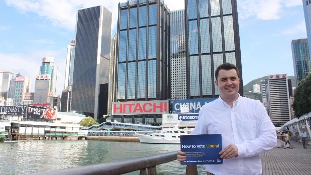 Dan Ryan handing out Liberal how-to-vote cards outside the Australian Consulate in Hong Kong.