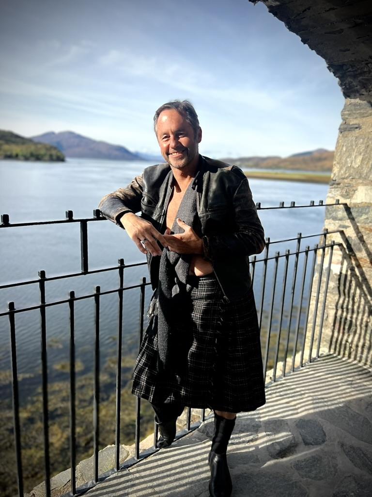 George Goulburn in his kilt and leather jacket at Eilean Donan castle.