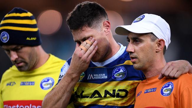 Mitchell Moses of the Eels reacts while being assisted from the field after sustaining a knee injury.