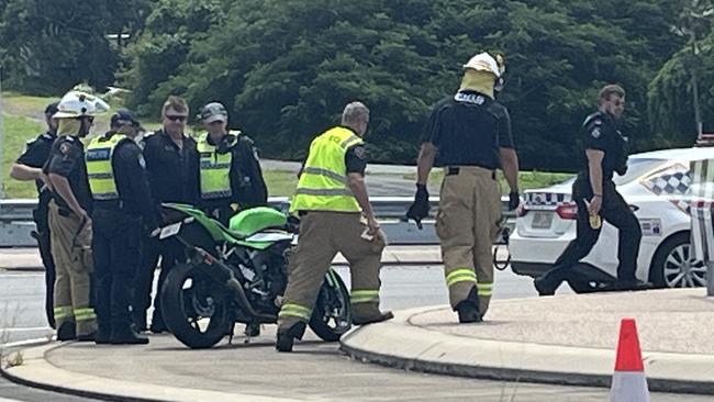 Toyota Corolla, motorbike crash on busy roundabout