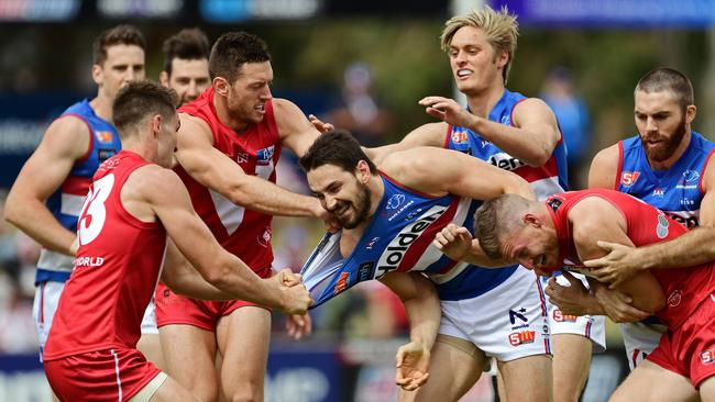 Central's John Butcher wrestles with North Adelaide opponents during the Good Friday season-opener at Elizabeth Oval. Picture: Tom Huntley