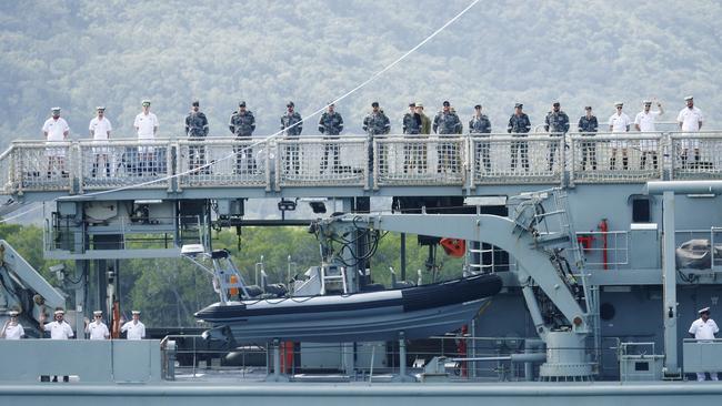 Royal Australian Navy sailors line the sternside deck of hydrographic ship HMAS Melville, as she returns to her home port of HMAS Cairns for the final time, after a six month deployment across northern Australian waters. Picture: Brendan Radke