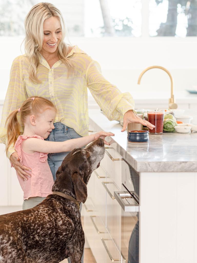 Ms Phillips with daughter Ella, 6, and family dog Diesel.