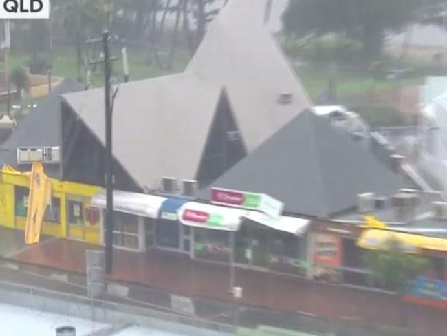 Steel awnings flap in the winds brought by Cyclone Debbie at Airlie Beach on the North Queensland coast. Picture: Today/Channel 9