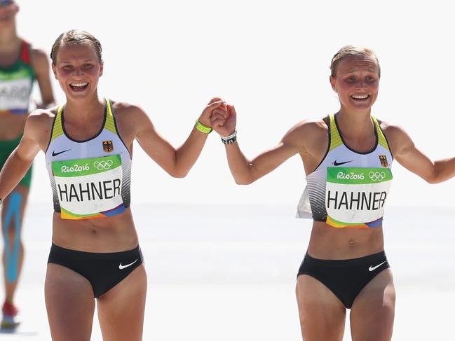 RIO DE JANEIRO, BRAZIL - AUGUST 14: Anna Hahner (L) of Germany and her sister Lisa Hahner reacts as thei approaches the finish line during the Women's Marathon on Day 9 of the Rio 2016 Olympic Games at the Sambodromo on August 14, 2016 in Rio de Janeiro, Brazil. (Photo by Alexander Hassenstein/Getty Images)