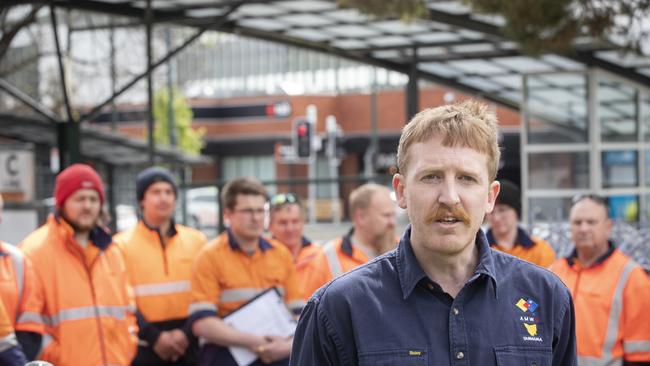 Jacob Batt, Australian Manufacturing Workers&#149; Union State Organiser with striking Metro mechanics at Glenorchy. Picture: Chris Kidd