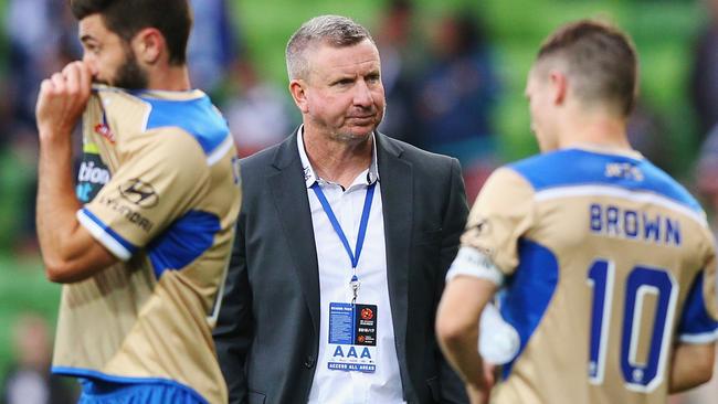 Newcastle Jets head coach Mark Jones looks dejected after defeat to Melbourne Victory.