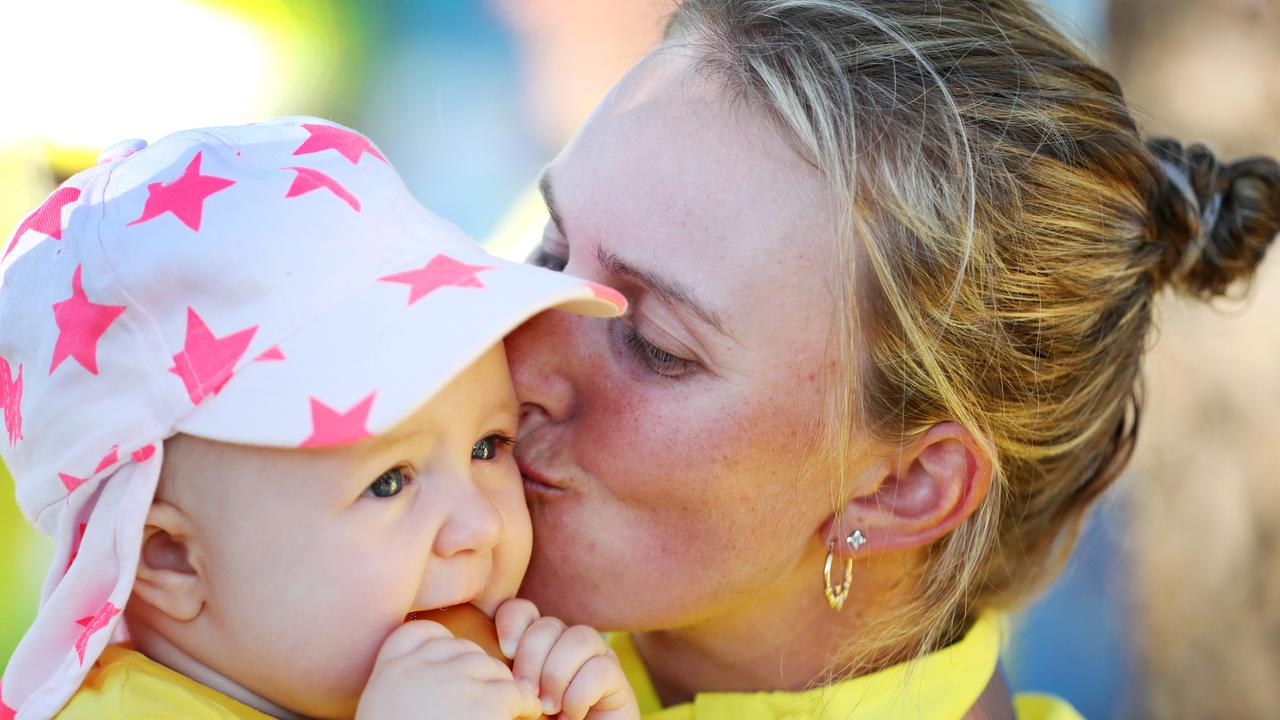 Kelsey Cottrell with her baby Sienna after winning gold. Picture: NIGEL HALLETT