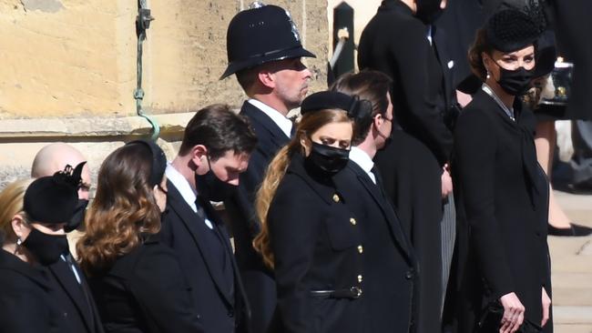 WINDSOR, ENGLAND - APRIL 17: Zara Tindall, Mike Tindall, Princess Eugenie, Jack Brooksbank, Princess Beatrice,  Edoardo Mapelli Mozzi, Catherine, Duchess of Cambridge and Camilla, Duchess of Cornwall stand outside St George's Chapel for the funeral service of Britain's Prince Philip, Duke of Edinburgh in Windsor Castle on April 17, 2021 in Windsor, United Kingdom. Prince Philip of Greece and Denmark was born 10 June 1921, in Greece. He served in the British Royal Navy and fought in WWII. He married the then Princess Elizabeth on 20 November 1947 and was created Duke of Edinburgh, Earl of Merioneth, and Baron Greenwich by King VI. He served as Prince Consort to Queen Elizabeth II until his death on April 9 2021, months short of his 100th birthday. His funeral takes place today at Windsor Castle with only 30 guests invited due to Coronavirus pandemic restrictions. (Photo by Jeremy Selwyn-WPA Pool/Getty Images)