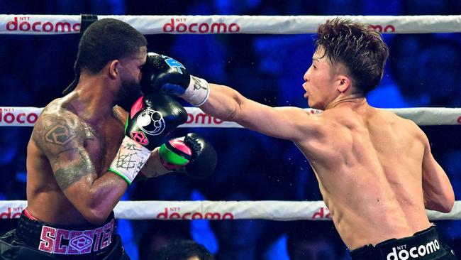 Naoya Inoue of Japan lands a punch to Stephen Fulton’s face. Photo by Kazuhiro NOGI / AFP.