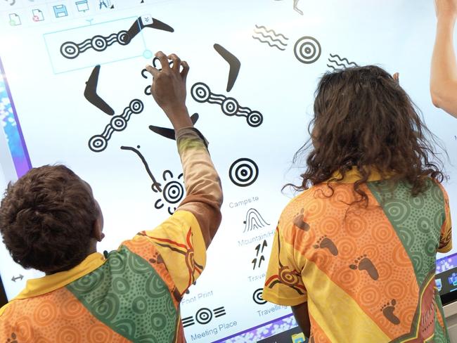 Jeff Lowe and Pat Caruso have introduced interactive Indigenous art through SMART Technology to a school in Alice. Picture: Colyn DeGraaff