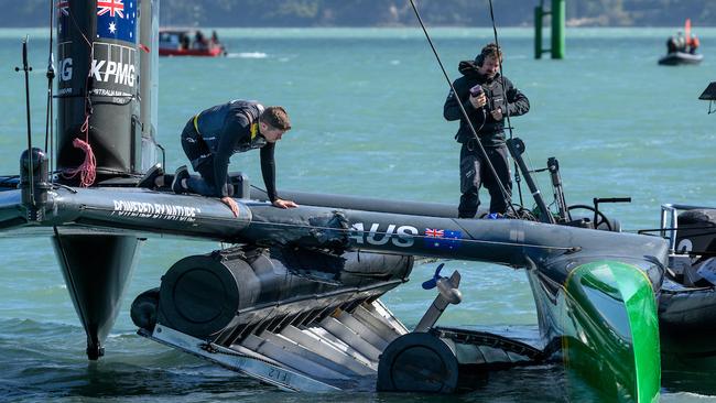 Tom Slingsby looks over the damage sustained to the F50 catamaran after they hit a finish line marker. Picture: Ricardo Pinto/SailGP.