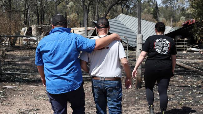 Mitch Kelly’s son comforts him. Picture: Liam Kidston