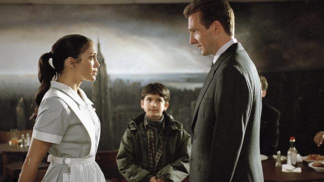 “I wonder if he realises he has gravy on his tie.” Actor Jennifer Lopez with Tyler Posey and Ralph Fiennes in scene from film "Maid in Manhattan". /Films/Titles/Maid/in/Manhattan 