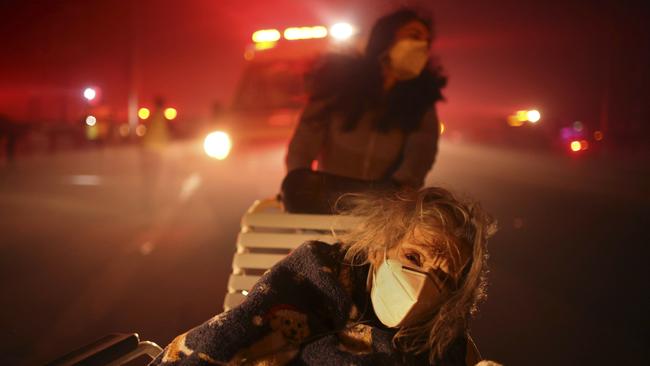 A resident of a senior center is evacuated as the Eaton Fire approaches. Picture: AP