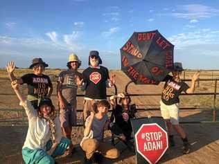 Front Line Action on Coal (FLAC) posted images of an Anti-Adani protest, captioned in part: Twenty people are blocking the access to the site of Adani's railway construction this morning, including three people, Kaiya, Bec and Ellie, who have locked on to the gates to stop work.