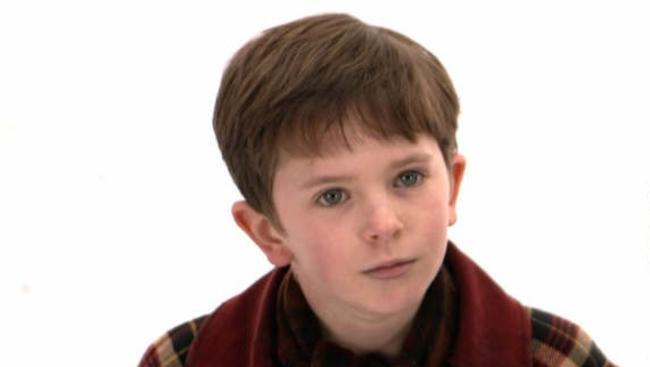 Child actor Freddie Highmore (Charlie) and David Kelly (Grandpa Joe) in a scene from the 2005 film Charlie and the Chocolate Factory - movies