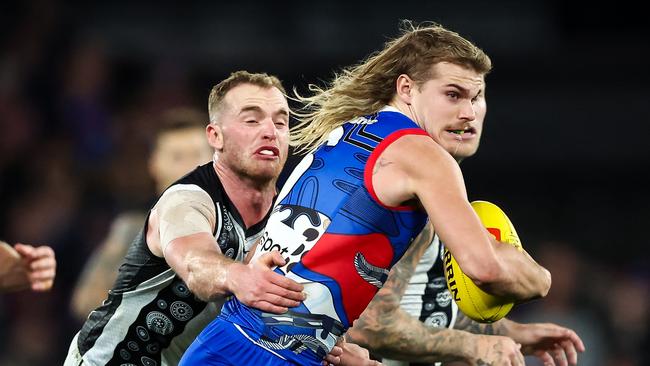 MELBOURNE, AUSTRALIA - JULY 07: Bailey Smith of the Bulldogs is tackled by Tom Mitchell of the Magpies during the 2023 AFL Round 17 match between the Western Bulldogs and the Collingwood Magpies at Marvel Stadium on July 7, 2023 in Melbourne, Australia. (Photo by Dylan Burns/AFL Photos via Getty Images)