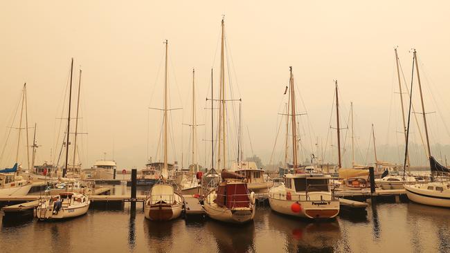 Yachts at Port Huon marina in thick smoke. Picture: NIKKI DAVIS-JONES