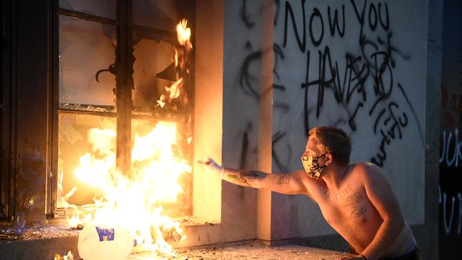 A protester starts a fire at the Metro Courthouse in Nashville, Tennessee.