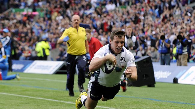 Scotland centre Mark Bennett scores a try against Italy at Murrayfield in Edinburgh.