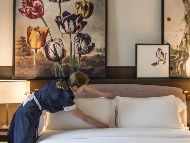 Chambermaid setting a bedroom at Hotel VilÃÂ²n in Rome