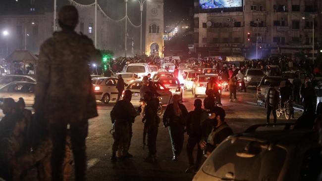 Residents take to the streets of Hama to welcome anti-government fighters after they took control of Syria's west-central city on Thursday. Picture: AFP