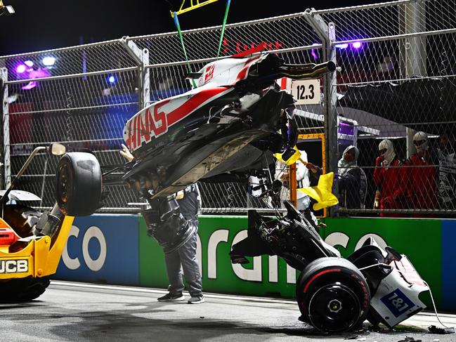 Track marshals clean up Mick Schumacher’s Haas after a crash during qualifying at the F1 Grand Prix of Saudi Arabia. Picture: Clive Mason/Getty Images