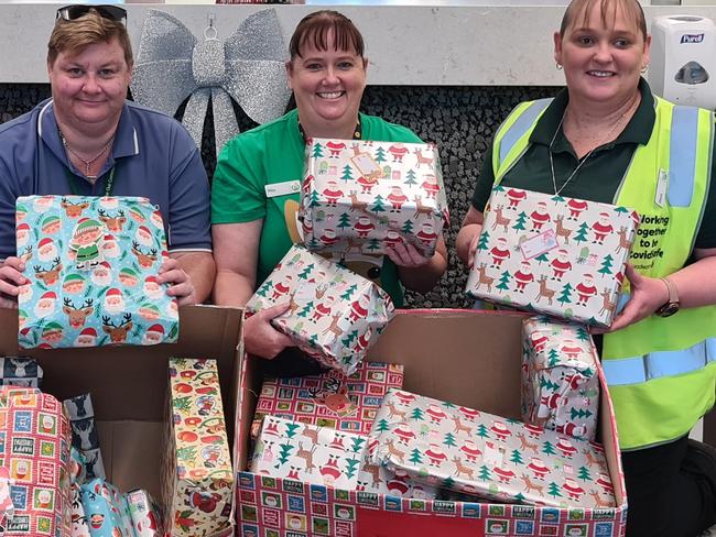 Rita Morris, second from right, is store services compliance officer at Woolworths Mildura Langtree. Pictured with Woolworths Mildura Langtree assistant store manager Rebecca Burton (right) and Mallee Accommodation and Support Program (MASP) team members Mia and Kelly (no surnames due to privacy policy). Rita organises a gift drive to give local foster kids Christmas presents every year. Pic supplied for Woolies Thanks a Million campaign only.