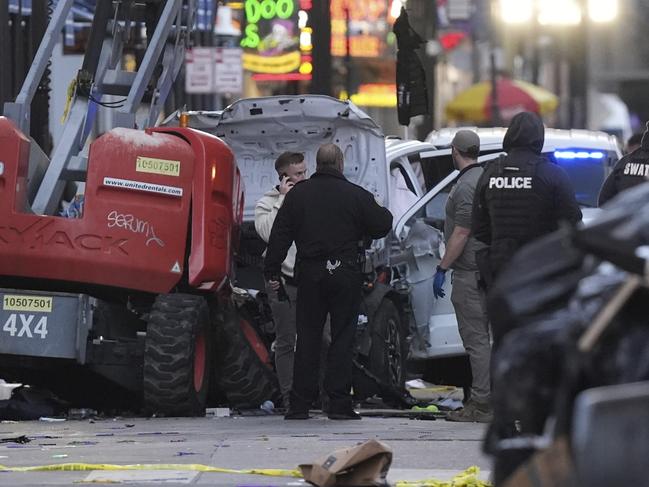 Emergency services attend the scene on Bourbon Street after a vehicle drove into a crowd on New Orleans' Canal and Bourbon Street, Wednesday Jan. 1, 2025. (AP Photo/Gerald Herbert)