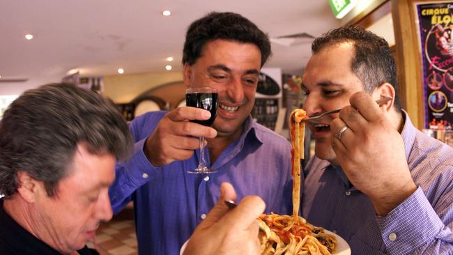 George Belperio with Jim Rinaldi and Frank Taddeo tucking into a plate of pasta at a Fasta Pasta in February, 2001.