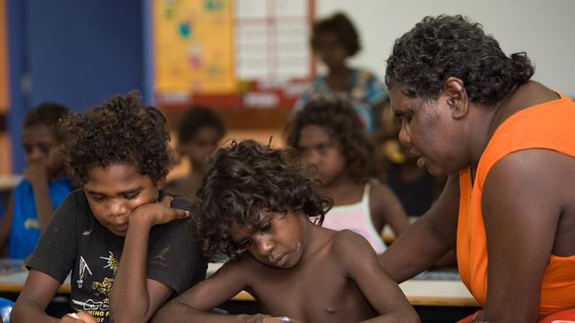 Aboriginal students with assistant teacher Roslyn Malngumba in the classroom during a class at Mapuru, Arnhem Land, Northern Territory.