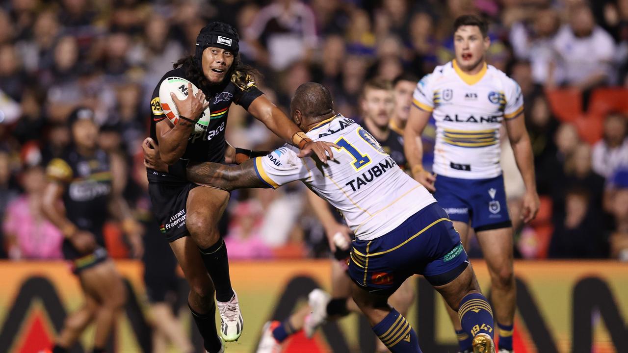 Jarome Luai of the Panthers is tackled by Junior Paulo. (Photo by Jason McCawley/Getty Images)