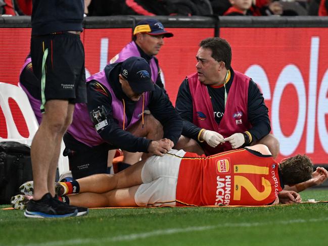 Jordan Dawson receives medical attention against Essendon. Picture: Daniel Pockett/Getty Images.