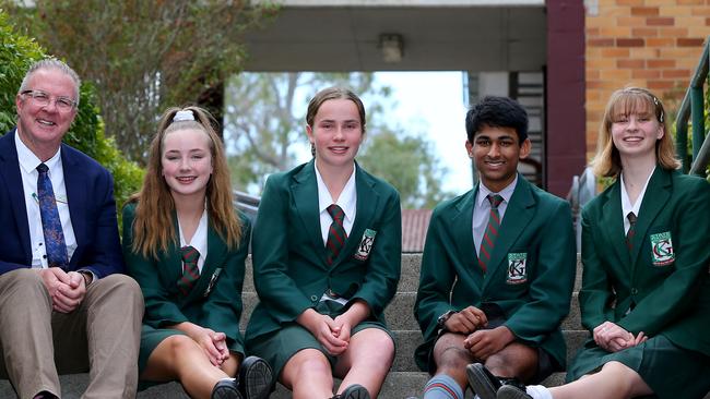 Students (from left) Lucy Kelly, Claudia Czerniawski, Aashay Tidke and Millie Williams at Kelvin Grove State College with executive principal Llew Paulger. The school has proposed dramatic changes to its enrolment policy to cope with a surge in enrolments. Picture: David Clark