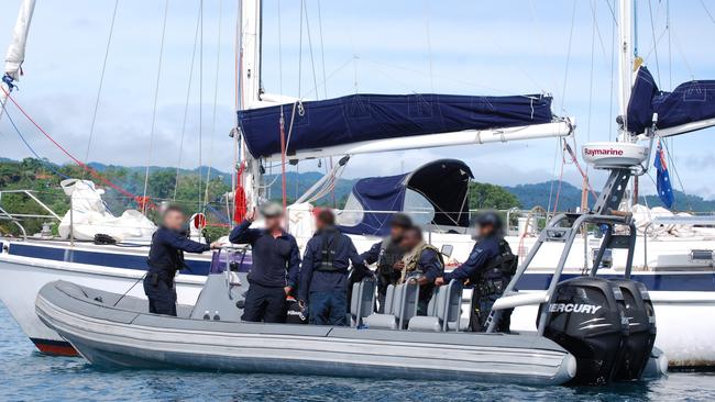 Soloman Islands law enforcement authorities prepare to board the vessel.