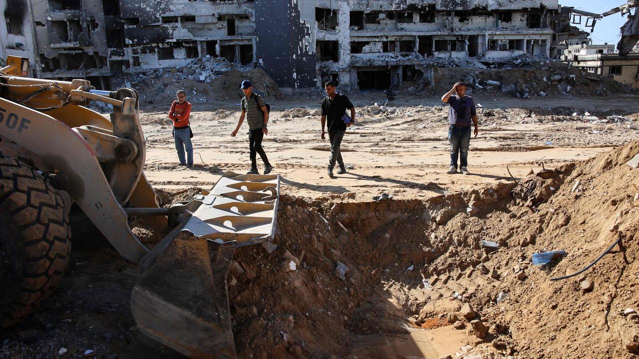 People use a bulldozer to search for bodies at the Al-Shifa medical complex in Gaza City. Picture: AFP