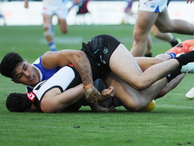 ADELAIDE, AUSTRALIA - APRIL 26: Josh Sinn of the Power is tackled by Paul Curtis of the Kangaroos during the 2025 AFL Round 07 match between the Port Adelaide Power and the North Melbourne Kangaroos at Adelaide Oval on April 26, 2025 in Adelaide, Australia. (Photo by James Elsby/AFL Photos via Getty Images)
