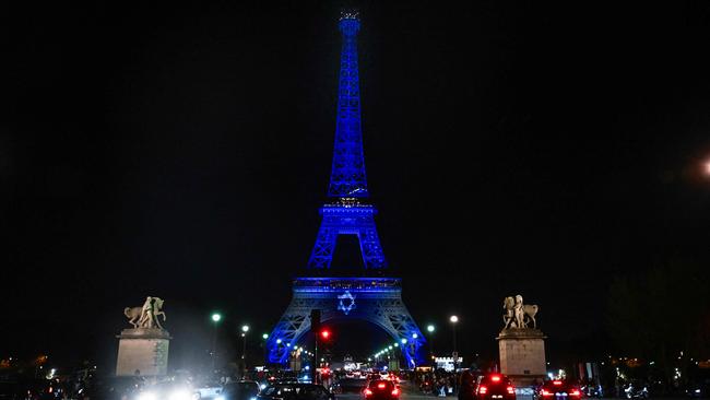 The Eiffel Tower is illuminated with the Star of David and the colours of national flag of Israel. Picture: AFP.