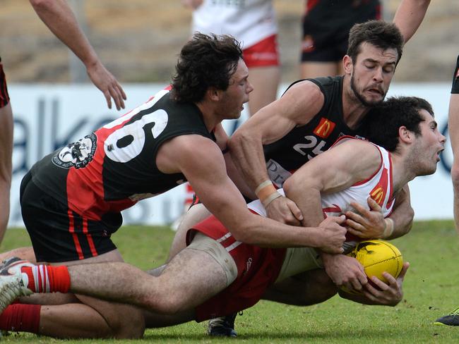 South Fremantle's Blaine Johnson is tackled by Perth's Toby Gianatti and Cody Leggett. Picture: Daniel Wilkins