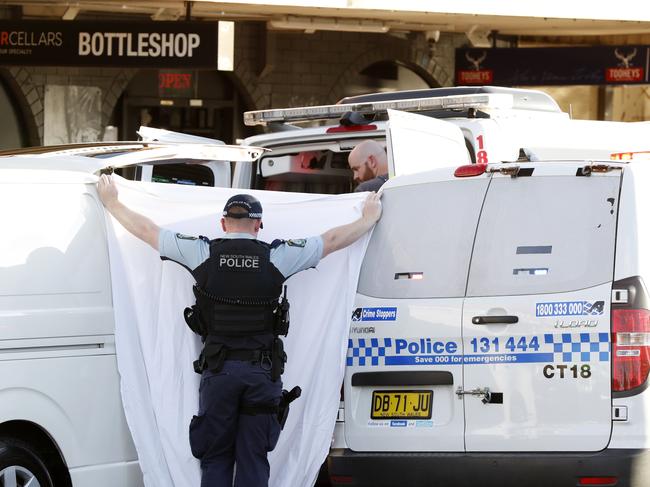 Police provide a privacy screen as the boy’s body is removed from the scene. Picture: Jonathan Ng