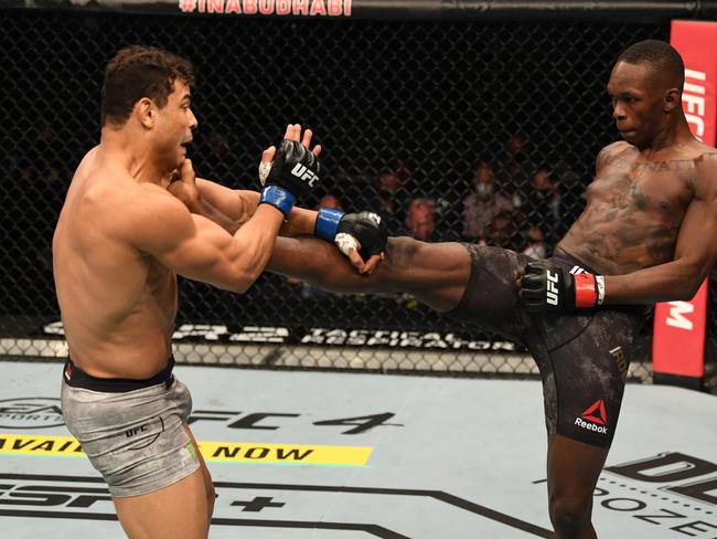 Israel Adesanya kicks Paulo Costa in their middleweight championship bout during UFC 253.