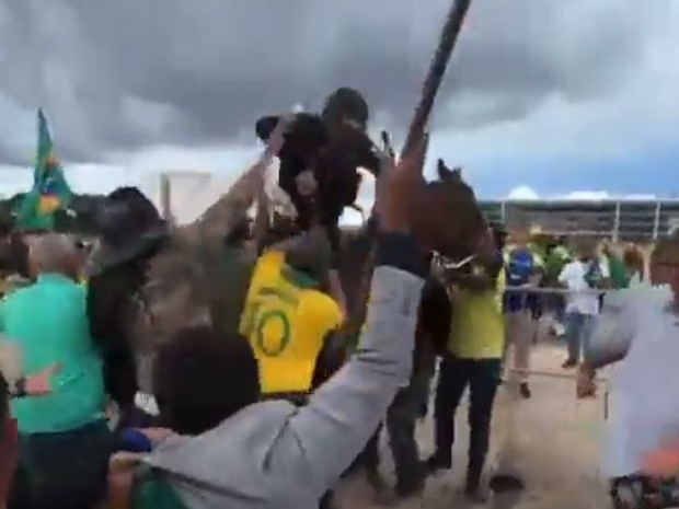 Bolsonaro supporters beat a police officer and the horse he is riding. Picture: Twitter