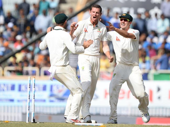 Australian bowler Josh Hazlewood celebrates with Pat Cummins after he dismissed Indian batsman Karun Nair