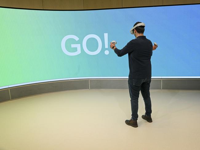 An attendee demonstrates Meta Oculus Quest 2 virtual reality headset and controllers during a media preview of the Meta Store in Burlingame, California. Picture: David Paul Morris/Bloomberg